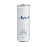 A single can of saltgood sea salt enhanced Canadian Spring Water on a solid white background. The can is white with a textured, condensation-covered finish and features the brand name 'saltgood' in a dark blue serif font, along with blue wave graphics and product details.